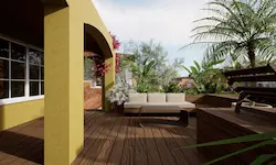 Zona de descanso con sofá empotrado y vegetación mediterránea en terraza sostenible