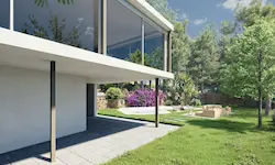 Outdoor lounge area with Mediterranean vegetation and a modern façade in Catalonia