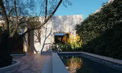 Narrow pool with heat‑resistant planting and stone edging suitable for dry, continental Mediterranean climates