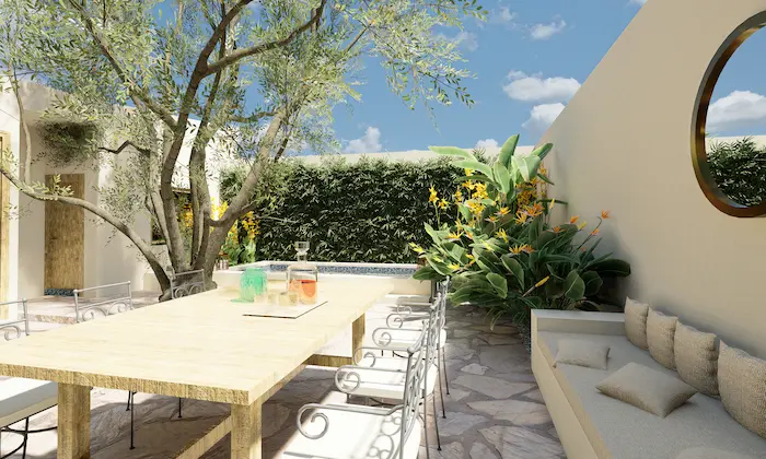 Outdoor dining area with cushioned bench, wooden table and tropical flowers in a landscaped Madrid courtyard